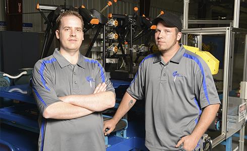 CNC programmer James Wardell and robotics technician Jeff Buck of Conroe Machine